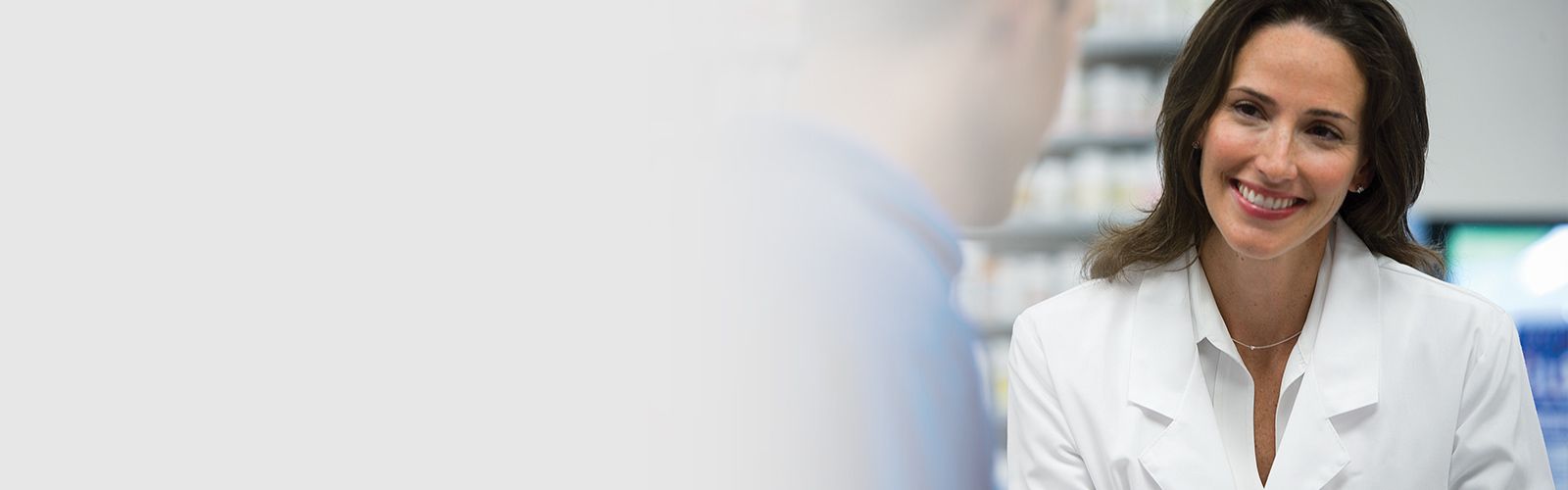 A pharmacist smiling at a customer