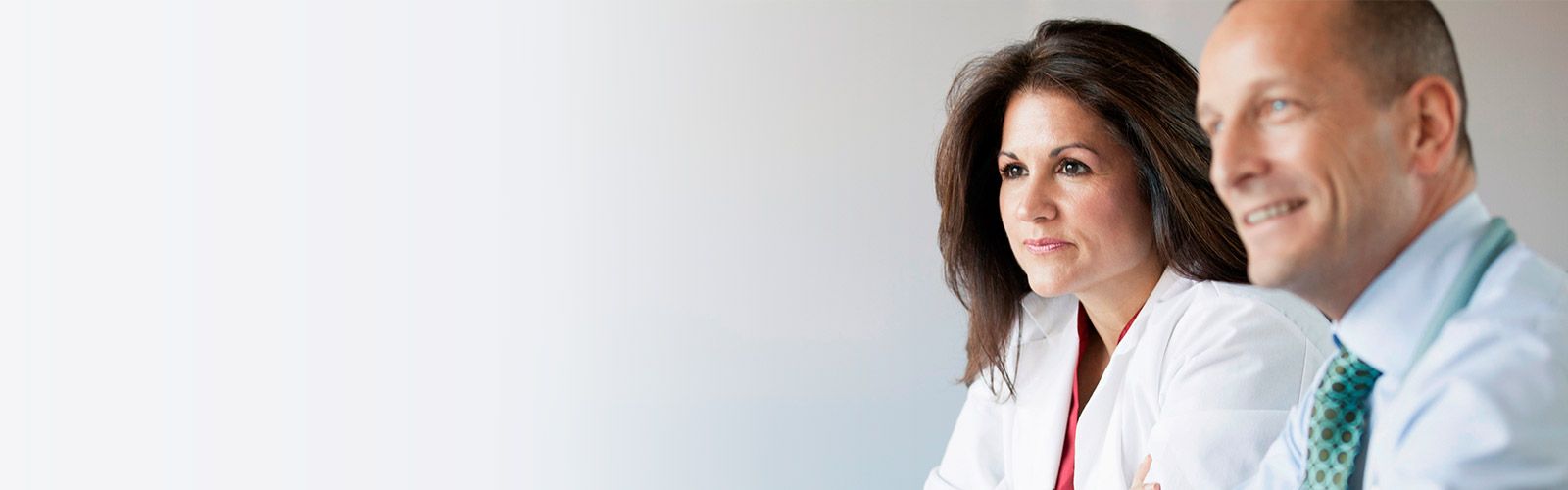 doctor and business professional sitting and looking content