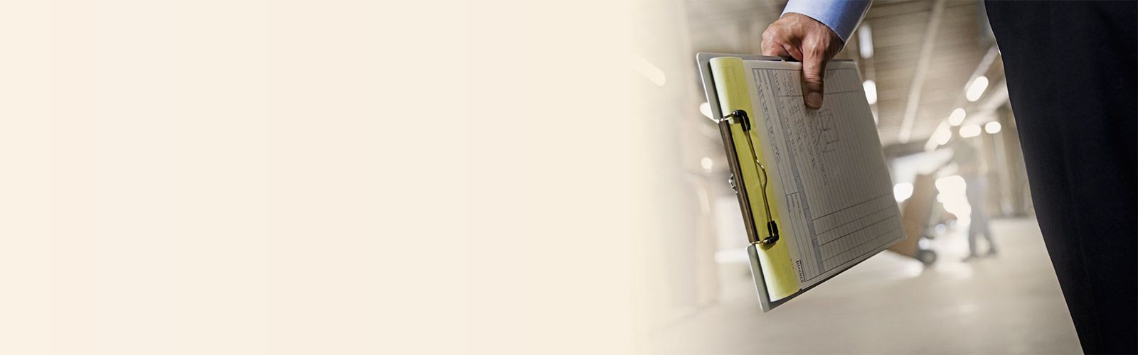 distribution center associate carrying clipboard