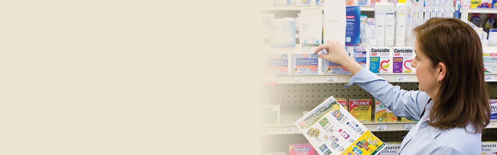 pharmacist holding ad flyer, selecting OTC medicine