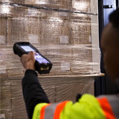 warehouse associate scanning shipment with device