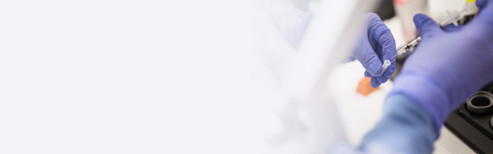 nuclear pharmacist preparing patient-specific radiopharmaceutical under hood