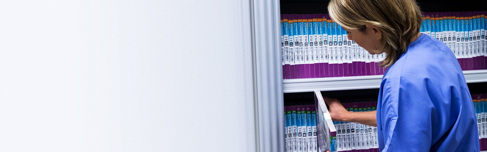 nurse stocking product on smart shelves.