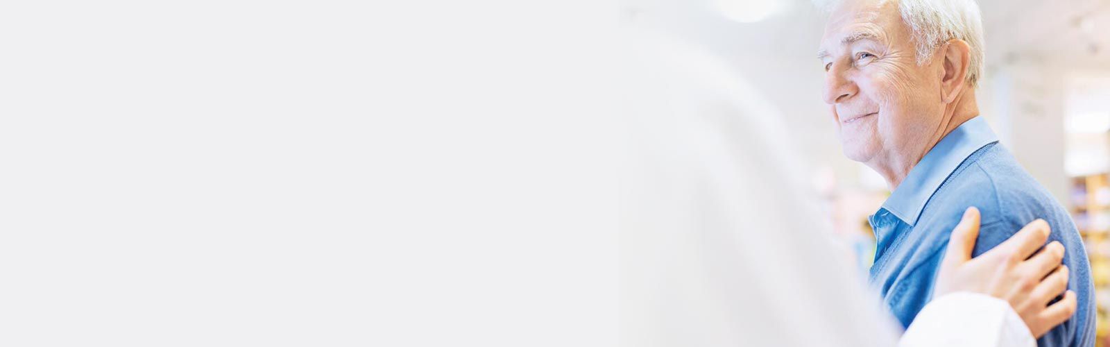 Doctor with his hand on a patient's shoulder.