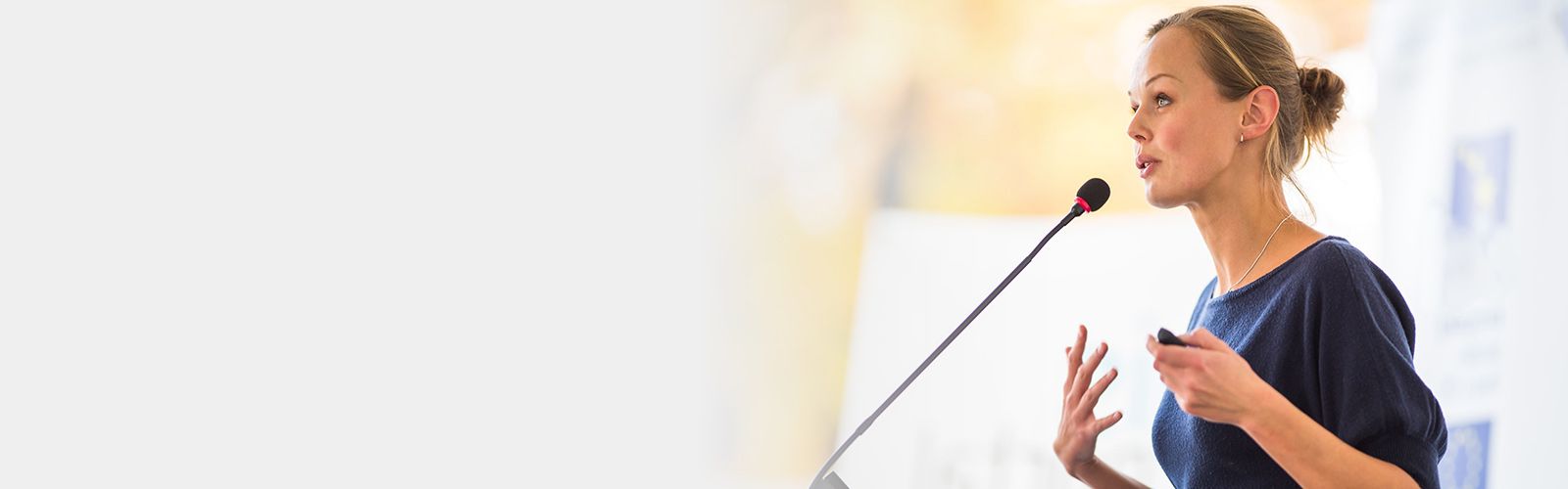 Woman speaking at podium.