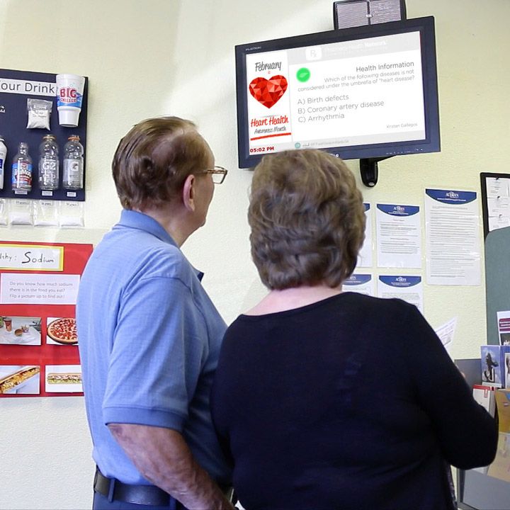 Elderly couple viewing Pharmacy Health Network material