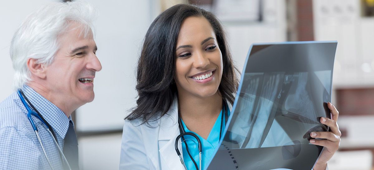 Image of two doctors looking at an X-ray