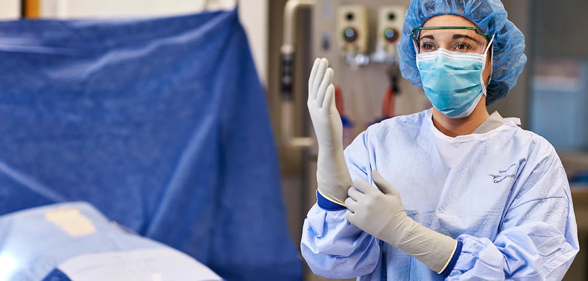 Image of a nurse putting on surgical gloves