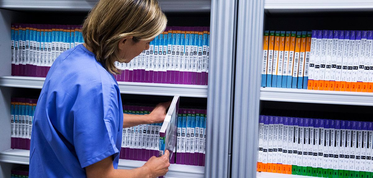 nurse stocking product on smart shelves.