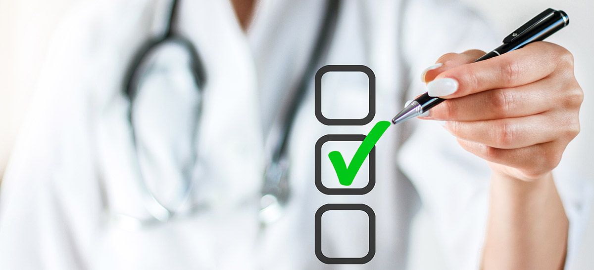 Image of a doctor checking off a box in a checklist