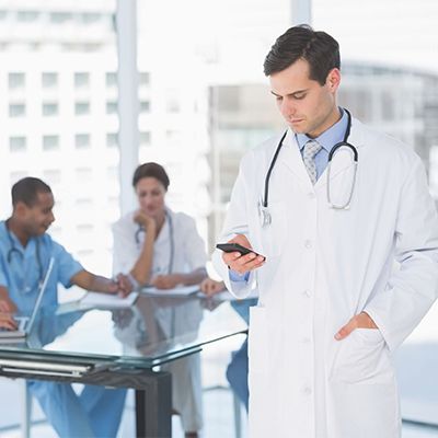 physicians in hospital meeting room reviewing information