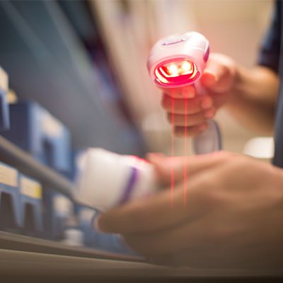 A healthcare provider scans a prescription bottle.