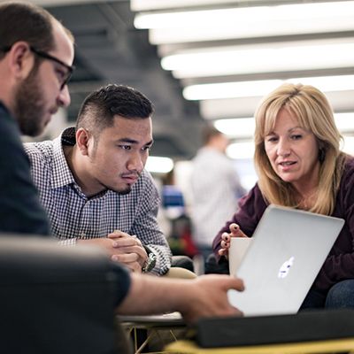 professionals reviewing information on a laptop