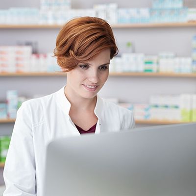 Female pharmacist looking at computer screen