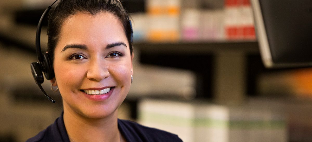 Smiling woman wearing a headset.