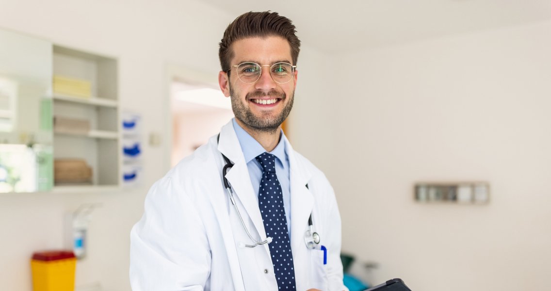 Oncologist smiling within an independent oncology practice