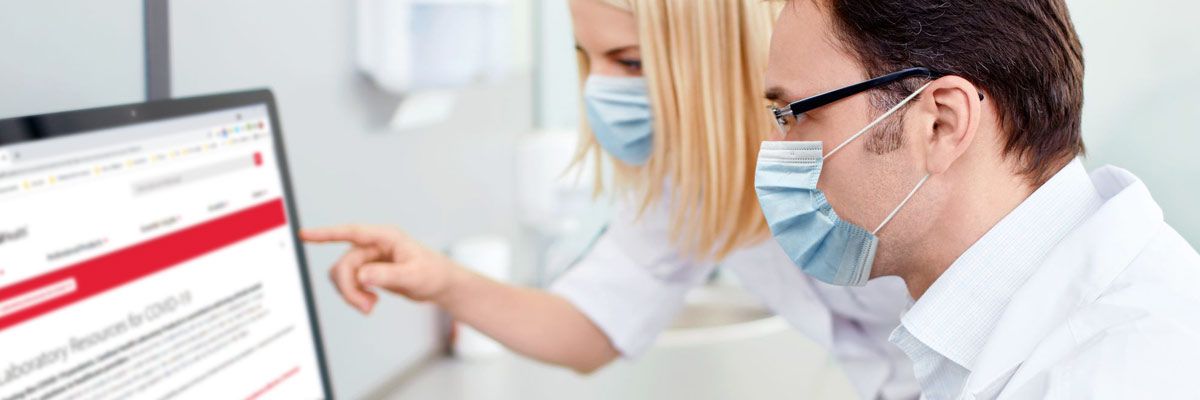 Two physicians looking at a tablet.