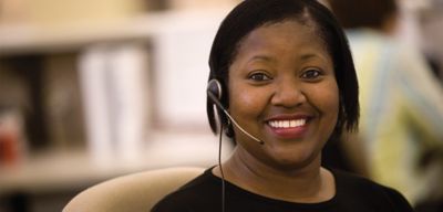 Women wearing a headset and smiling 