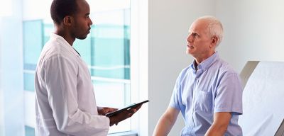 Doctor talking to mature male patient.
