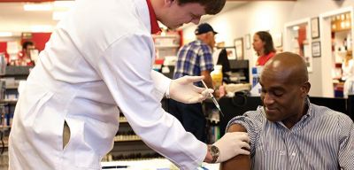 Pharmacist giving a patient an immunization.