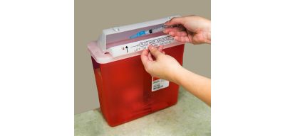 Disposing of a needle into a sharps container.