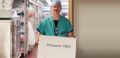 Medical professional in scrubs holding a Presource PBDS box.